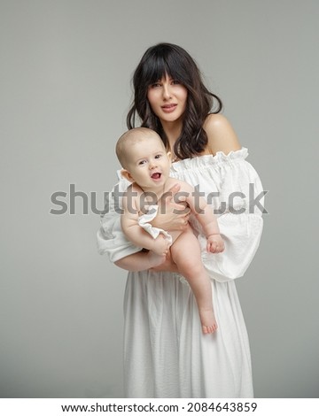 Mom and baby. Mom in a white dress with a baby. Mother and son. motherhood. Love for son.