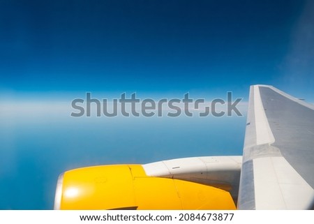 View from the plane window: flying above the clouds. Clear blue sky. Travel and tourism, air transport and nature concept. Horizontal photo. Bodrum, Turkey, Europe.