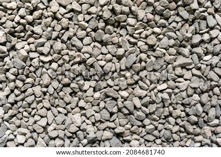 Batu split coffee shop. Grey ballast stone surface. Texture of ballast rock bed. Floor covered by gray rocks small pebble materials. Royalty-Free Stock Photo #2084681740