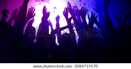 Photo of carefree bachelors clubbers fellows enjoy nightlife dj rock band show raise hands up on bright filter festival soft focus