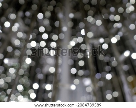 Abstract christmas background in bokeh. lights of blinking garland in blur. Unsharp bulbs of Christmas decorations. Festive mood. Animated background for text or pictures. New Year holiday