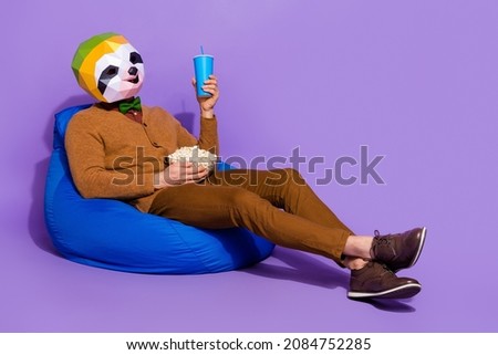 Full length photo of sloth head person sit bag enjoy free time isolated on purple color background
