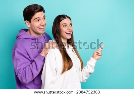 Photo of excited crazy couple look copyspace see huge discounts good offer isolated on blue color background