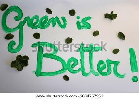 green lettering with leaves on a white background