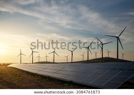 Solar panels and wind turbines generating renewable energy for green and sustainable future. Royalty-Free Stock Photo #2084761873