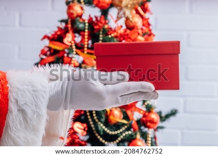santa claus hands with christmas gifts