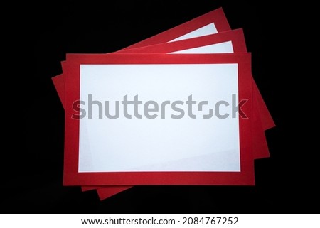 White letterheads with a red frame on a black isolate. A blank sheet for a warning ad on a black background. A pack of clean stickers.