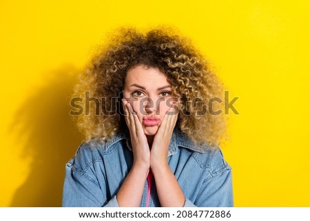 Photo of bored exhausted annoyed irritated lady hands cheeks wear jeans shirt isolated yellow color background