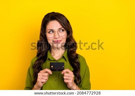 Photo of lovely lady hold card look empty space take savings wear specs green shirt isolated yellow color background