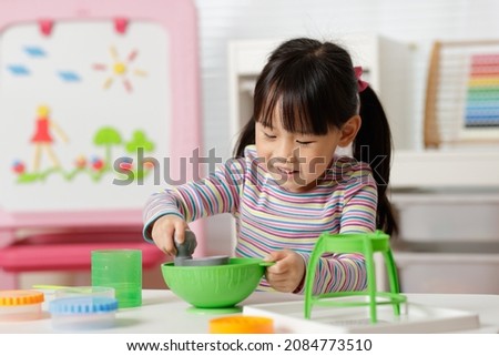 young girl making slime at home