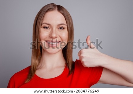 Photo of young cheerful girl show thumb-up advertise approve perfect quality isolated over grey color background