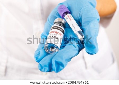 covid 19 OMICRON (B.1.1.529) Variant vaccine in hand on the white background. vaccination against coronavirus