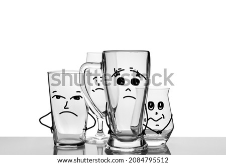 Empty beer glasses with drawn sad faces. Non-alcoholic Friday concept composition. Alcoholism