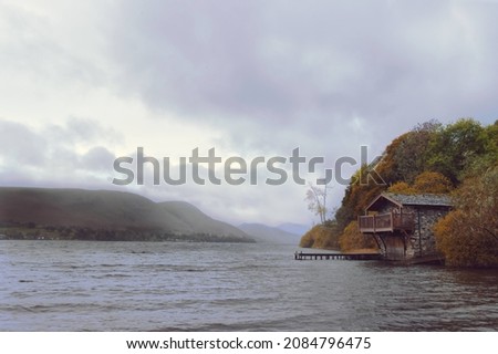 The boathouse in The Lakes on a cold autumn day.  Royalty-Free Stock Photo #2084796475