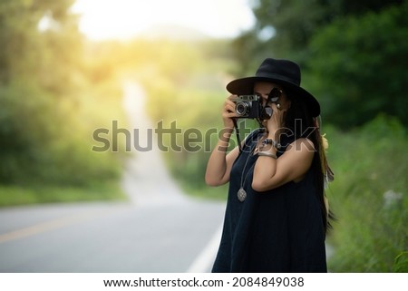 Travel route with traveling woman wearing hat with vintage camera autumn mood