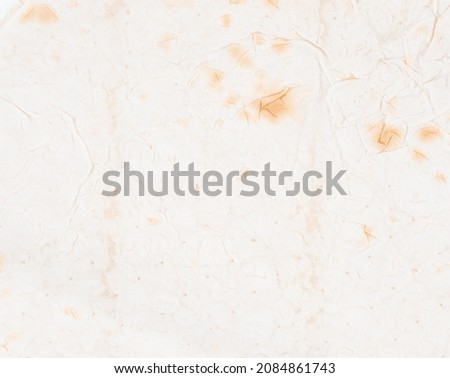 Lavash, texture of thin traditional freshly baked oriental bread, background Armenian lavash. Texture of thin traditional freshly baked homemade oriental bread. Close-up Armenian pita bread - lavash Royalty-Free Stock Photo #2084861743