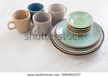 ceramic cups and plates on white marble table Royalty-Free Stock Photo #2084864107