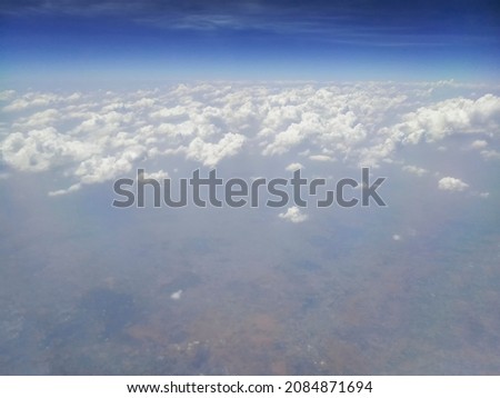 Nice white clouds in the atmosphere, image shot in the sky from aeroplane. Nature stock image.