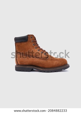 Brown winter boots isolated on white background. Sneaker. Cool shoes
