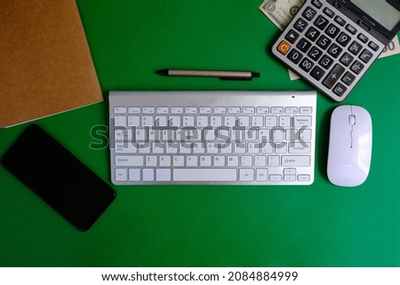 Minimal office desk workplace with book, smartphone, pencil copy space on wood background. Top view. Flat lay style