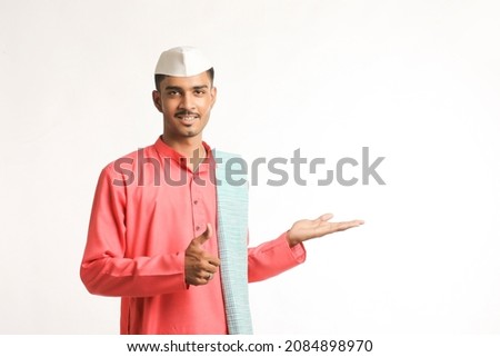 young indian man in traditional wear and showing expression on white background