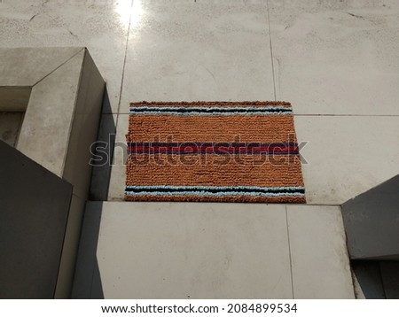 doormat in front of access to public bathroom