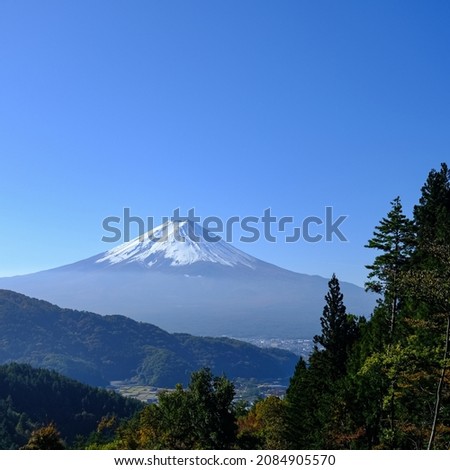 Beautiful mountain Fuji with snow and green hill with clear sky background in Japan. Mt Fuji is one of famous mountain.