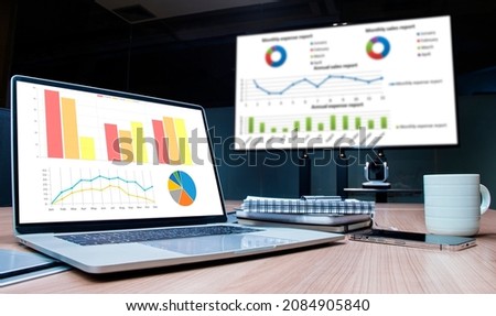 Mock up chart slide show presentation on display television and laptop in meeting room Royalty-Free Stock Photo #2084905840