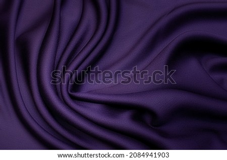 Abstract background texture of natural violet, purple or lilac color fabric. Fabric texture of natural cotton or linen, silk or satin, wool or jersey textile material. Luxurious modern canvas textile. Royalty-Free Stock Photo #2084941903