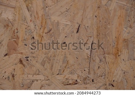 Chipboard (fiberboard) texture. Wooden material. Selective focus. Top view.