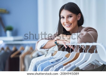 Young woman as a store manager with clothes
