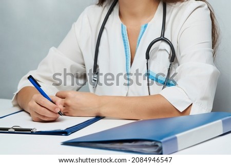Female doctor working at office desk. Portrait of a woman doctor on white background, close-up