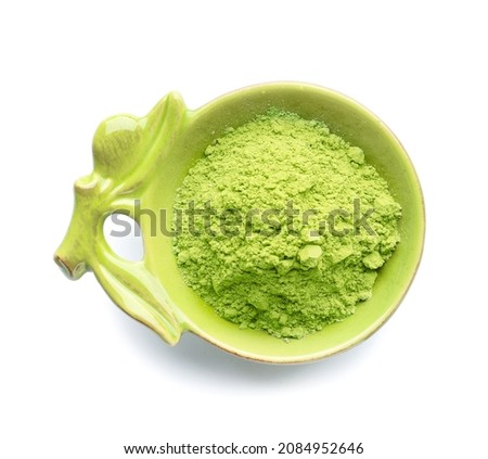 Bowl with powdered matcha tea on white background