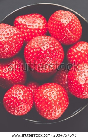 Strawberries in a bowl. Black background. Studio shooting