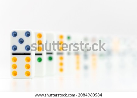 Dominoes. Dominos pieces with colorful dots in row on white background. Leadership concept