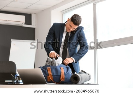 Young businessman going to go to gym after working day in office Royalty-Free Stock Photo #2084965870