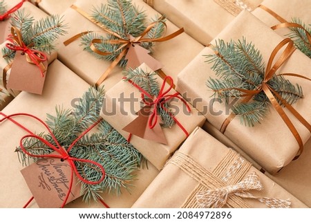 Christmas presents with fir branches as background
