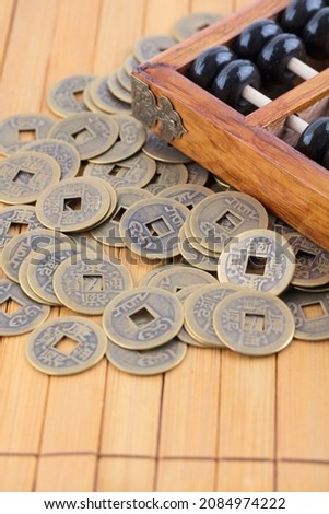 Abacus beads on bamboo slips and scattered copper coins