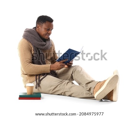 African-American man reading book on white background