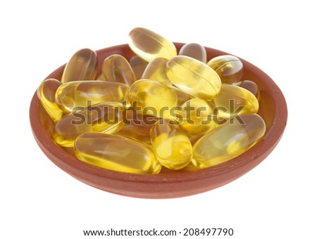 A group of cod liver oil capsules in a small red clay dish.