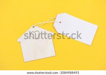Eco friendly house with blank sign on yellow background