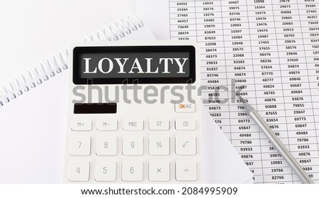 Calculator with text LOYALTY on notebook . Business, finance conceptual.