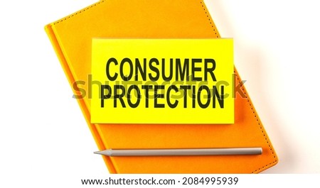 Text CONSUMER PROTECTION on sticker on yellow notebook