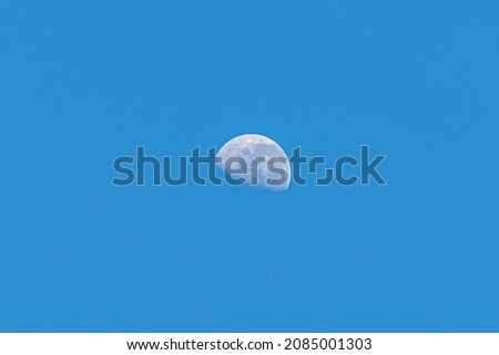 waning gibbous of moon in day isolated blue background