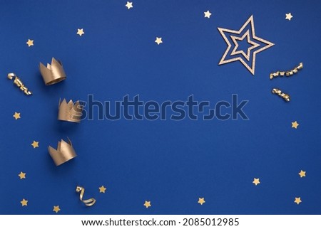 Happy Three King's Day, of January 6. Three gold crowns on blue background. Concept for Dia de Reyes Magos day, three Wise Men. Epiphany day. Top view, copy space, flat lay.