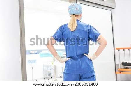 Doctor or nurse stands in front of the emergency room or intensive care unit in the hospital