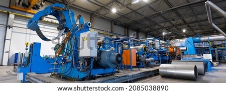 Panoramic photo. Metal sheet profile forming machine, process of making steel tile for roof, industrial manufacturing. Background of plant and factory