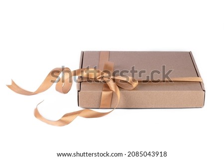 Holiday or Christmas gift boxes background. Gift box wrapped in Kraft paper with ribbon on white background.