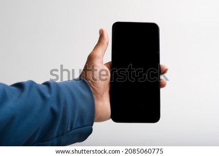 holding smartphone in hand on white background