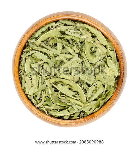 Dried lemon verbena leaves in a wooden bowl. Dry leaves of Aloysia citrodora also known as lemon beebrush. Used as herbal tea, in potpourri, for flavoring food and liqueur and in traditional medicine. Royalty-Free Stock Photo #2085090988